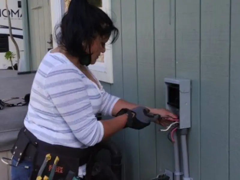 Licensed electrician wiring an exterior subpanel in Elburn